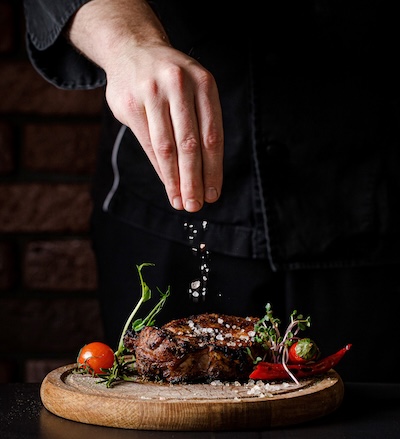 msg sprinkled on steak and vegetables