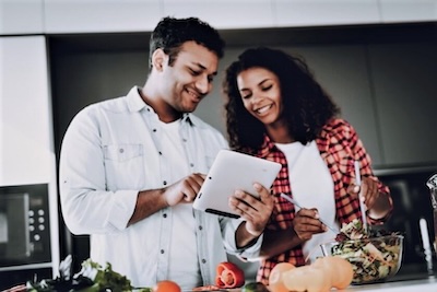 MSG on the menu couple reading tablet while cooking